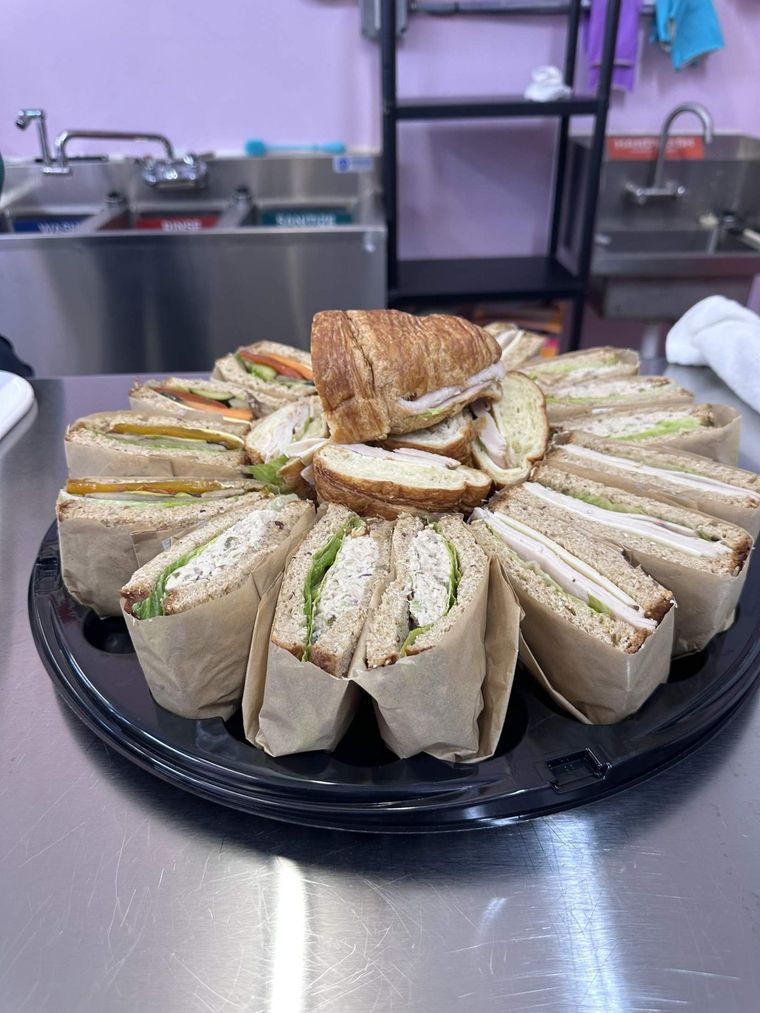 A Peace of Mine sandwich platter of wrapped sandwiches and turkey croissants